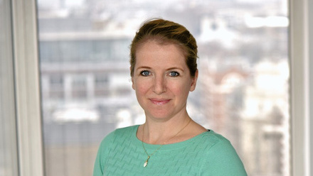 Headshot: Maartje Horchner, a woman with dark hair tied back, wearing a green top.