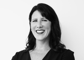 Headshot: Amanda Brill, a black and white image of a woman with dark hair.