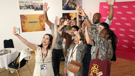 Sheffield DocFest Filmmaker Challenge Cohort waving their hands in the air and taking a selfie.