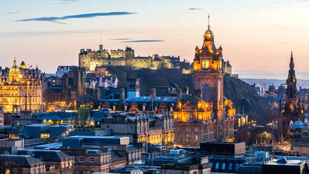 Rooftop view of Edinburgh skyline with the castle in the far distance.