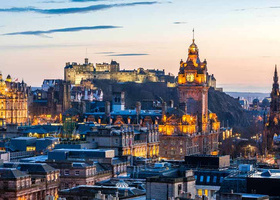 Rooftop view of Edinburgh skyline with the castle in the far distance.