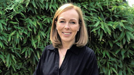 Headshot: Nicola Ibison, a woman with a blonde bob wearing a black shirt.
