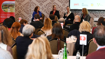 Delegates sat at tables listening to a panel discussion at Pact's Content Without Borders conference.