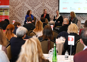 Delegates sat at tables listening to a panel discussion at Pact's Content Without Borders conference.