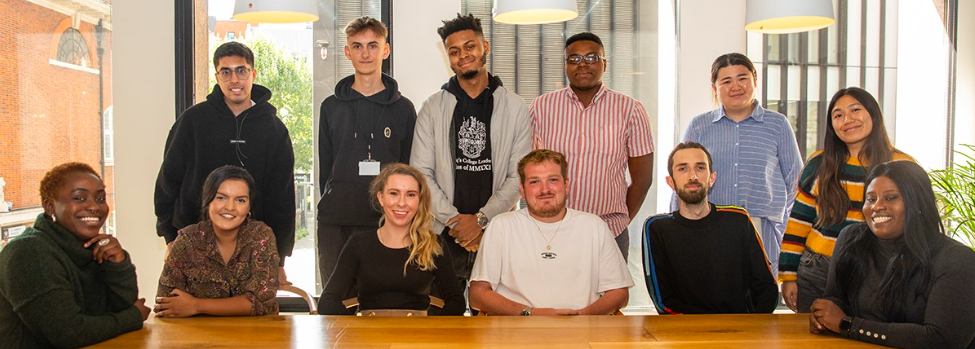 Photo of the group of participants on the 2022 Pact Indie Diversity Scheme, some sat in the front row others standing behind.
