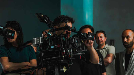 Film crew operating advanced equipment working together on a set.