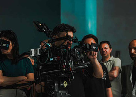 Film crew operating advanced equipment working together on a set.