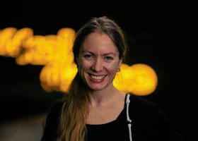 Headshot: Katharina Gellein Viken, a woman with long hair tied in a ponytail wearing a black top.