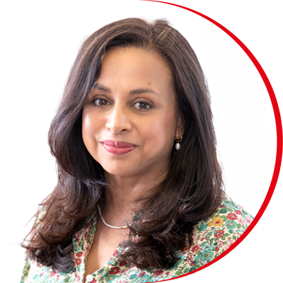 Headshot: Anjani Patel, a woman with long dark hair wearing a floral shirt.
