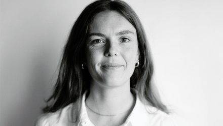 Headshot: Charlotte Westlake, a woman with long, dark hair, wearing a collared shirt.