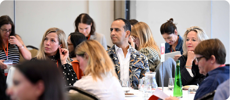 Delegates at Content Without Borders sit and listen attentively to a panel discussion taking place out of frame.