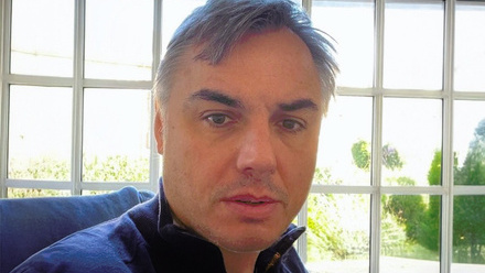 Headshot: Simon Huntley, a man with short, grey hair wearing a blue-collared top.