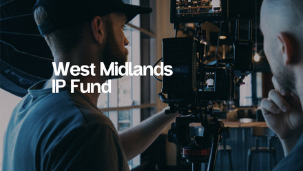 Two men operate a professional camera setup inside a modern, dimly lit studio or workspace. Overlaid white text reads 'West Midlands IP Fund'