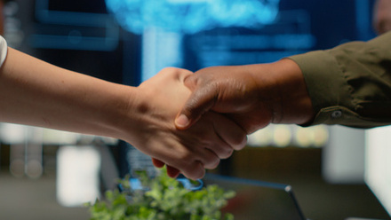 A firm handshake in an office environment