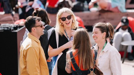 SXSW delegates networking outside in the sun.