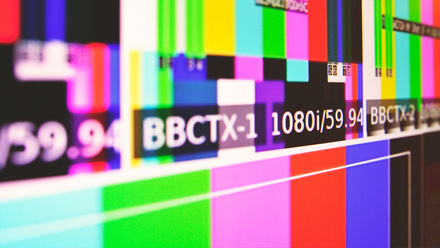 Photo image of a screen with broadcast colour bars on them and the words BBCtx-1 1080i