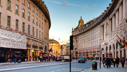 Regent Street in London lined with shops and distinctive architecture.
