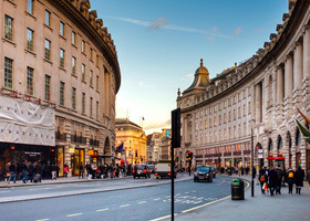 Regent Street in London lined with shops and distinctive architecture.
