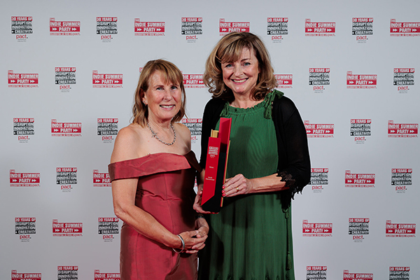 Anne Brogan and Melanie Stokes of Kindle Entertainment holding their Tribute trophy