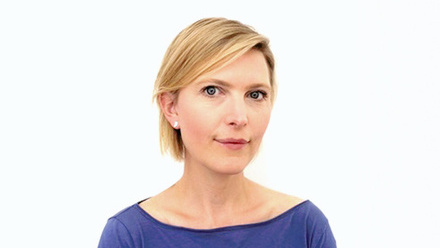 Headshot: Emily Smith, a woman with short, blonde hair wearing a blue top.