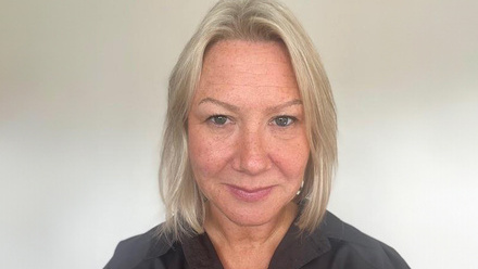 Headshot: Samantha Lawrence, a woman with shoulder-length blond hair wearing a black shirt.