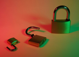 An image of three gold padlocks on a green and red gradient background.
