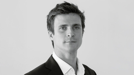 Headshot: Edward Lane, a young man with short hair in a shirt and blazer.