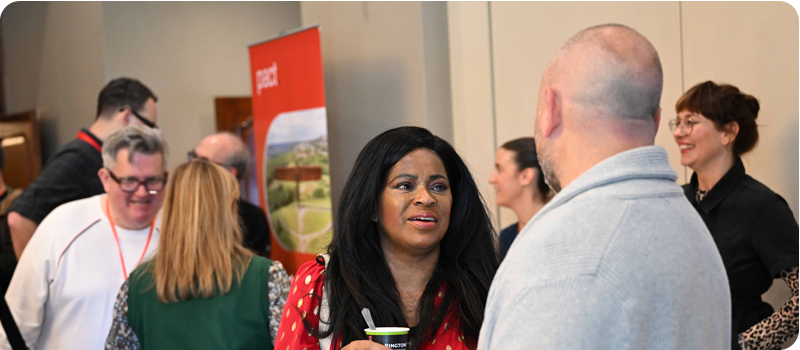 A busy room of delegates stood up networking at Content Without Borders